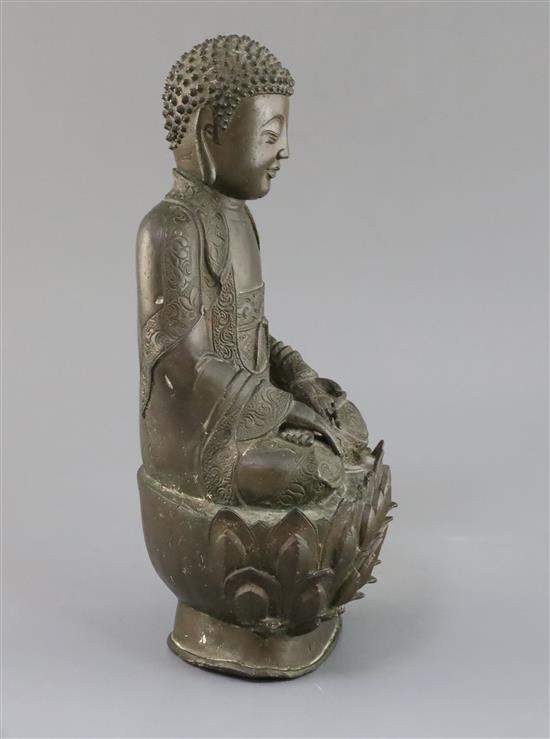 A Chinese bronze seated figure of Buddha Shakyamuni, 17th century, H. 32cm